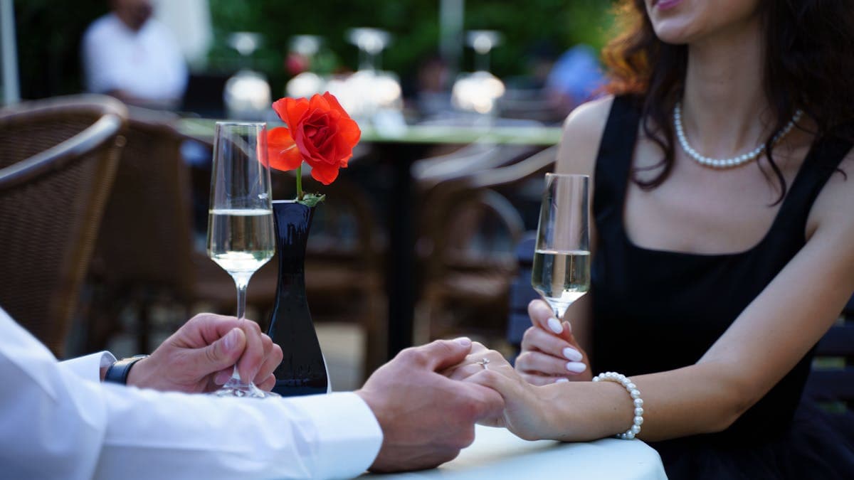 Couple on a romantic dinner date at an elegant restaurant in Winter Park Florida with champagne