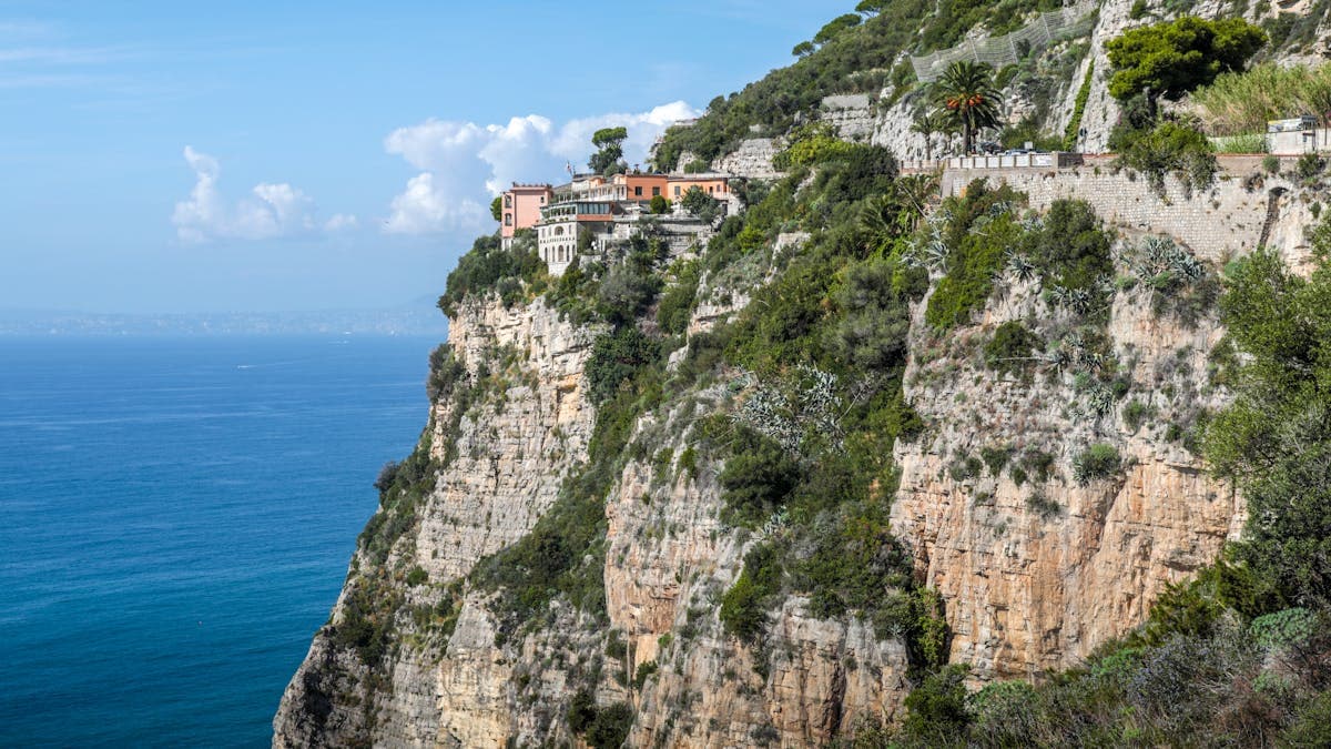 Stunning cliffside view of the Amalfi Coast, Italy, with colourful village buildings cascading down to the turquoise sea